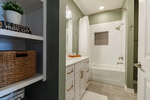 Bathroom with built-in shelving and tub at 1677 54th Ave N, 336, Nashville, TN 37209