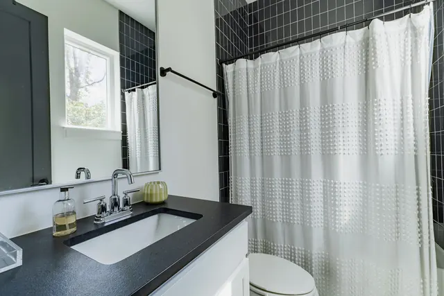 Bathroom with black tile surround at 505 Croley Dr, Nashville, TN 37209